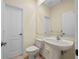 Cozy bathroom featuring a pedestal sink and standard toilet at 650 Crane Prairie Way, Osprey, FL 34229