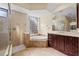 Large bathroom featuring a glass shower, soaking tub, and double vanities at 650 Crane Prairie Way, Osprey, FL 34229