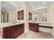 Bathroom featuring double vanities with beautiful dark wood cabinetry at 650 Crane Prairie Way, Osprey, FL 34229