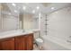 Bathroom with cherry wood cabinetry and a shower-tub combo at 650 Crane Prairie Way, Osprey, FL 34229