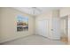 Bright bedroom with window, closet, and carpet at 650 Crane Prairie Way, Osprey, FL 34229