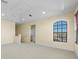 Bright bonus room with tray ceiling, large arched window, and neutral tones at 650 Crane Prairie Way, Osprey, FL 34229
