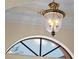 Close up of an elegant vintage chandelier hanging from tray ceiling at 650 Crane Prairie Way, Osprey, FL 34229