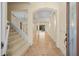 Inviting foyer featuring arched doorways, tiled floors, and a staircase, creating an elegant entrance at 650 Crane Prairie Way, Osprey, FL 34229