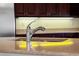 Modern kitchen sink with a chrome faucet and granite countertop, complemented by dark wood cabinetry at 650 Crane Prairie Way, Osprey, FL 34229