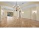 Spacious living area with natural light, chandelier, and smooth flooring perfect for gathering and relaxing at 650 Crane Prairie Way, Osprey, FL 34229