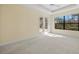 Spacious main bedroom with tray ceiling, French doors, and large windows at 650 Crane Prairie Way, Osprey, FL 34229