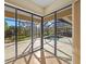 View of a refreshing pool area from inside the house through sliding glass doors at 650 Crane Prairie Way, Osprey, FL 34229