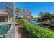 Tranquil pool area with lush landscaping and water views at 650 Crane Prairie Way, Osprey, FL 34229