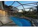 Screened-in pool area with water view, perfect for relaxing and entertaining at 650 Crane Prairie Way, Osprey, FL 34229