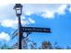 Street sign displaying 'Crane Prairie Way' against a sunny sky, indicating the neighborhood's location at 650 Crane Prairie Way, Osprey, FL 34229