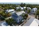 Aerial view of a beautiful beach home with lush landscaping at 6940 Longboat S Dr, Longboat Key, FL 34228