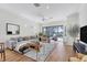 Open-concept living room with a cozy sectional sofa and access to a pool at 7116 Presidio Gln, Lakewood Ranch, FL 34202
