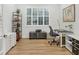 Home office with built-in shelving, desk, and hardwood floors at 7116 Presidio Gln, Lakewood Ranch, FL 34202
