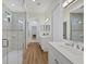 Bright bathroom boasts double vanity, glass shower, and elegant tile at 7116 Presidio Gln, Lakewood Ranch, FL 34202