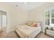 Well-lit bedroom with a light-colored walls, neutral carpet, and a window with white shutters at 7116 Presidio Gln, Lakewood Ranch, FL 34202