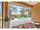 Relaxing screened lanai with comfortable seating and a view of the sparkling pool and beautiful landscaping at 7116 Presidio Gln, Lakewood Ranch, FL 34202