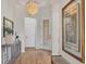 Bright and airy foyer with wood floors, elegant chandelier, and entry to other rooms at 7116 Presidio Gln, Lakewood Ranch, FL 34202