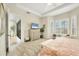 Spacious main bedroom offers neutral decor, a ceiling fan, and access to a screened lanai at 7116 Presidio Gln, Lakewood Ranch, FL 34202
