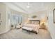 Bright main bedroom boasts neutral paint, tray ceiling, carpet, and plentiful natural light from shuttered windows at 7116 Presidio Gln, Lakewood Ranch, FL 34202