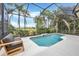 Inviting screened-in pool area with lush landscaping and seating, perfect for relaxing and entertaining at 7116 Presidio Gln, Lakewood Ranch, FL 34202