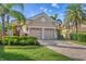 Tan two-car garage house with landscaping at 7116 Presidio Gln, Lakewood Ranch, FL 34202