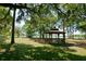 Relaxing gazebo shaded by oak trees, overlooking a lake at 7547 Silver Fern Blvd # 54, Sarasota, FL 34241