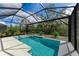 Refreshing screened pool with a spa and lush landscaping at 9281 Ballaster Pointe Loop, Parrish, FL 34219