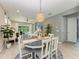 Bright dining room with round table and chairs, view into living room and kitchen at 9281 Ballaster Pointe Loop, Parrish, FL 34219