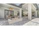 Covered patio features an outdoor fireplace and access to the kitchen at 9291 Swaying Branch Rd, Sarasota, FL 34241