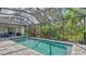 Relaxing screened pool and lanai with outdoor seating and lush landscaping at 9291 Swaying Branch Rd, Sarasota, FL 34241
