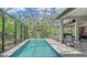Lush, screened-in pool with plenty of natural light at 9291 Swaying Branch Rd, Sarasota, FL 34241