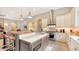 Gourmet kitchen with large island, stainless steel appliances, and white cabinets at 9291 Swaying Branch Rd, Sarasota, FL 34241