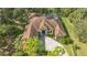 Aerial view of a luxurious home with a tile roof and pool at 9291 Swaying Branch Rd, Sarasota, FL 34241