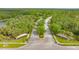 Aerial view of the community entrance with paved roads and landscaping at 9291 Swaying Branch Rd, Sarasota, FL 34241