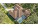 Aerial view of home with tile roof, pool, and lush landscaping at 9291 Swaying Branch Rd, Sarasota, FL 34241