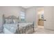 Cozy bedroom showcasing decorative metal bed frame and ensuite bathroom access at 9291 Swaying Branch Rd, Sarasota, FL 34241
