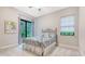 Bright bedroom features large windows, neutral colors, and a decorative metal bed frame at 9291 Swaying Branch Rd, Sarasota, FL 34241