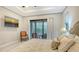 Comfortable bedroom features TV and sliding glass doors to the patio at 9291 Swaying Branch Rd, Sarasota, FL 34241