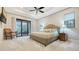 Spacious bedroom with tray ceilings and a sliding door leading to outdoor lounge at 9291 Swaying Branch Rd, Sarasota, FL 34241