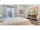 Serene bedroom offers private patio access and a mounted television at 9291 Swaying Branch Rd, Sarasota, FL 34241