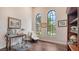 Home office features hardwood floors, large windows, built-in shelving, and a desk at 9291 Swaying Branch Rd, Sarasota, FL 34241