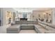 L-shaped sectional sofa in open living space with kitchen and dining area at 9291 Swaying Branch Rd, Sarasota, FL 34241