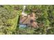 Aerial view of home showcasing tile roof, pool, and lush landscaping at 9291 Swaying Branch Rd, Sarasota, FL 34241
