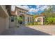 Attractive home exterior with tile roof, arched entryway and landscaped grounds at 9291 Swaying Branch Rd, Sarasota, FL 34241