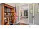 Home office with built-in shelves, American flag, and view to living room at 9291 Swaying Branch Rd, Sarasota, FL 34241