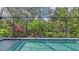 Screened-in pool with tropical landscaping at 9291 Swaying Branch Rd, Sarasota, FL 34241