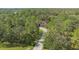 Aerial view showing home and long driveway surrounded by trees at 9291 Swaying Branch Rd, Sarasota, FL 34241
