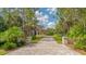 Long paver driveway leading to a beautiful home at 9291 Swaying Branch Rd, Sarasota, FL 34241