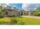 Mediterranean-style home with a three-car garage and lush landscaping at 9291 Swaying Branch Rd, Sarasota, FL 34241